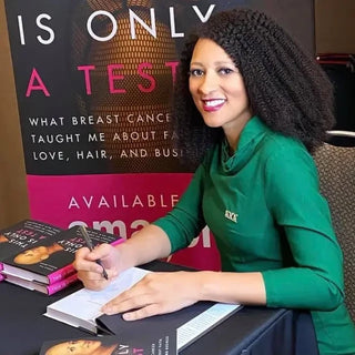 Chris-Tia Donaldson signing copies of her book This Is Only a Test