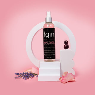 tgin Rose Water Curl Refresher on a white stand with rose petals and lavender
