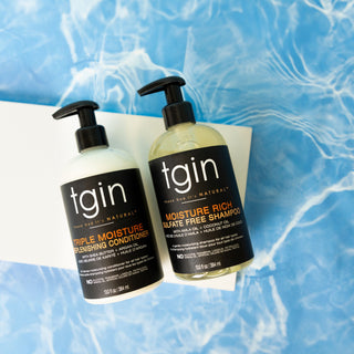 tgin Triple Moisture Replenishing Conditioner and Moisture Rich Sulfate Free Shampoo pump bottles over rippling blue water