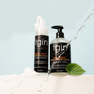 tgin Curl Bomb Moisturizing Styling Gel and Honey Whip Hydrating Mousse with a stream of water and a green leaf