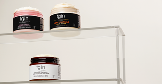 tgin Rose Water, Honey Miracle and Miracle RepaiRx hair mask jars on clear shelves