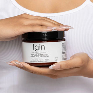 Hands holding a jar of tgin Miracle RepaiRx CPR Protein Treatment