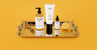 tgin Balance Collection products on a silver tray, yellow background