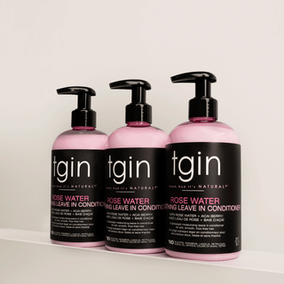 Three bottles of tgin Rose Water Smoothing Leave-In Conditioner on a white shelf