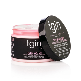 Open jar of tgin Rose Water Hydrating Curl Cream with lid leaning against it