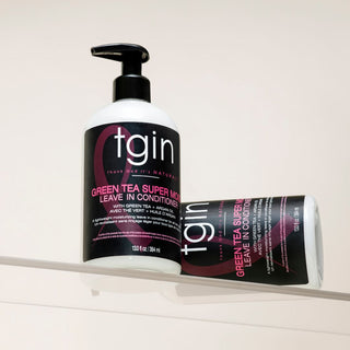 Two tgin Green Tea Super Moist Leave In Conditioner bottles on a glass shelf