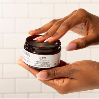 Hands holding an open tgin jar