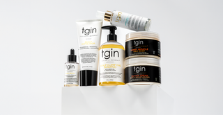 Assortment of tgin hair products on a white pedestal