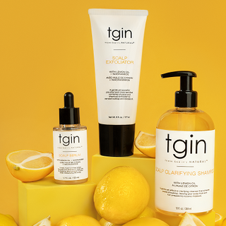 tgin Balance Scalp Serum, Scalp Exfoliator and Scalp Clarifying Shampoo with lemons on a yellow background
