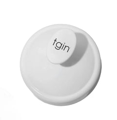 White tgin Scalp Massager seen from above, showing the tgin logo on the handle