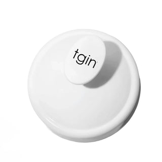 White tgin Scalp Massager seen from above, showing the tgin logo on the handle