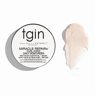 tgin Miracle RepaiRx Curl Food Daily Moisturizer jar lid next to a swatch of the pale pink cream