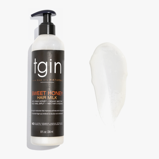 tgin Sweet Honey Hair Milk pump bottle with a swatch of the hair milk