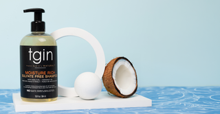 tgin Moisture Rich Sulfate Free Shampoo with a coconut and a white sphere on a blue water background